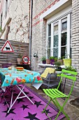 Colourful garden furniture and road signs in courtyard