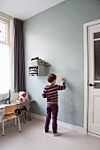 Boy drawing on wall