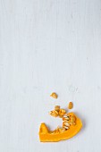 A pumpkin wedge with pumpkin seeds
