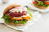 A veggie burger with a beetroot patty, goats' cheese and vegetable spirals