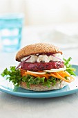 A veggie burger with a beetroot patty, goats' cheese and vegetable spirals