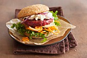 A veggie burger with a beetroot patty, goats' cheese and vegetable spirals