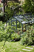 Greenhouse in summery garden