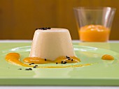 Ginger cream pudding with mango puree and sesame seeds