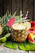 Pineapple smoothie with green tea, ginger and lime in a hollowed pineapple