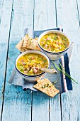Corn chowder (American sweetcorn soup) with diced ham and crackers