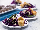 Breaded sheep cheese with lemon and red cabbage