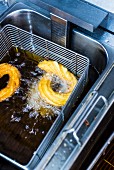 Churros in a deep fat fryer with oil
