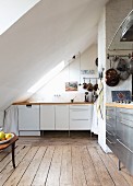 Kitchen with various fronts under sloping ceiling