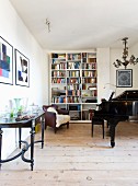 Antiques, grand piano and bookcase in living room