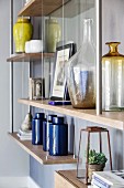 Various vases on wall-mounted shelves