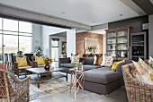 Sofa set and wicker furniture in lounge with concrete ceiling beams