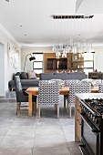 Upholstered chairs around dining table in open-plan interior