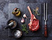 Raw fresh meat Veal rib Steak on bone and seasonings on dark background