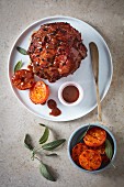 Studded baked ham with a toffee glaze and grilled clementines