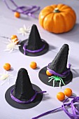 Black witches' hats decorating table for Halloween party