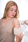 Girl having injection in arm