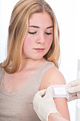 Girl with plaster on arm