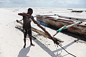 Fire-hardening a ngalawa boat,Zanzibar