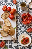 Ingredients for bruschetta al pomodoro (tomatoes, bread, garlic, olive oil and salt)