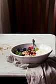 Yogurt with fresh berries and porridge oats in a bowl
