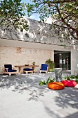 Colourful seating on terrace of modern house