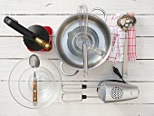 Kitchen utensils for making creme brulee with bay leaf and lemon peel