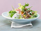 A green salad with a poached egg, sliced ham, a tofu dressing and croutons