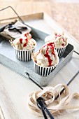 Raspberry ripple ice cream in paper cups on a metal tray