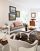 White wooden furniture and cowhide rug in living room