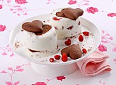 A woodland strawberry dessert with heart-shaped chocolate biscuits tipped out onto a plate