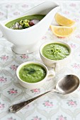 Cold vegan avocado soup in a gravy boat and cups