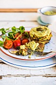 Quinoa fritters with an avocado dip and tomato salad