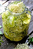Homemade elderflower syrup with lime in a flip-top glass jar