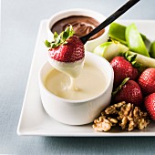 Strawberry dipping in white sauce