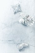 Silver Christmas decorations on marble surface