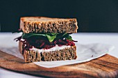 A toasted sandwich with beetroot and spinach