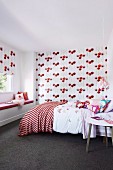 Matching patterned roller blind and wallpaper in the red and white girl's room
