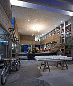 Bookcase in open-plan interior of concrete house