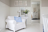 White armchair against wainscoting