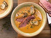 Red lentil soup with mushrooms and duck breast