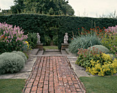 Path made of clinker and concrete slabs between perennial beds