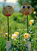 Clay faces as garden art