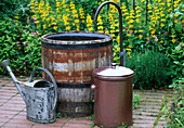 Wooden barrel with curved water inlet as fountain