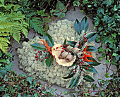 Grave decoration: Moss heart with privet leaves, rosehip twigs