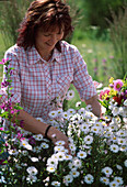 Young woman cutting a bouquet of flowers