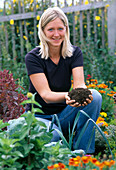 Young woman brings compost (Good Earth)