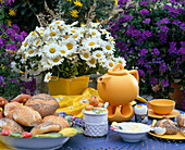 Breakfast table with bouquet of daisies