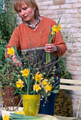 Woman making a bouquet of hazelnut branches