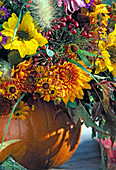 Hollowed out pumpkin as vase for bouquet